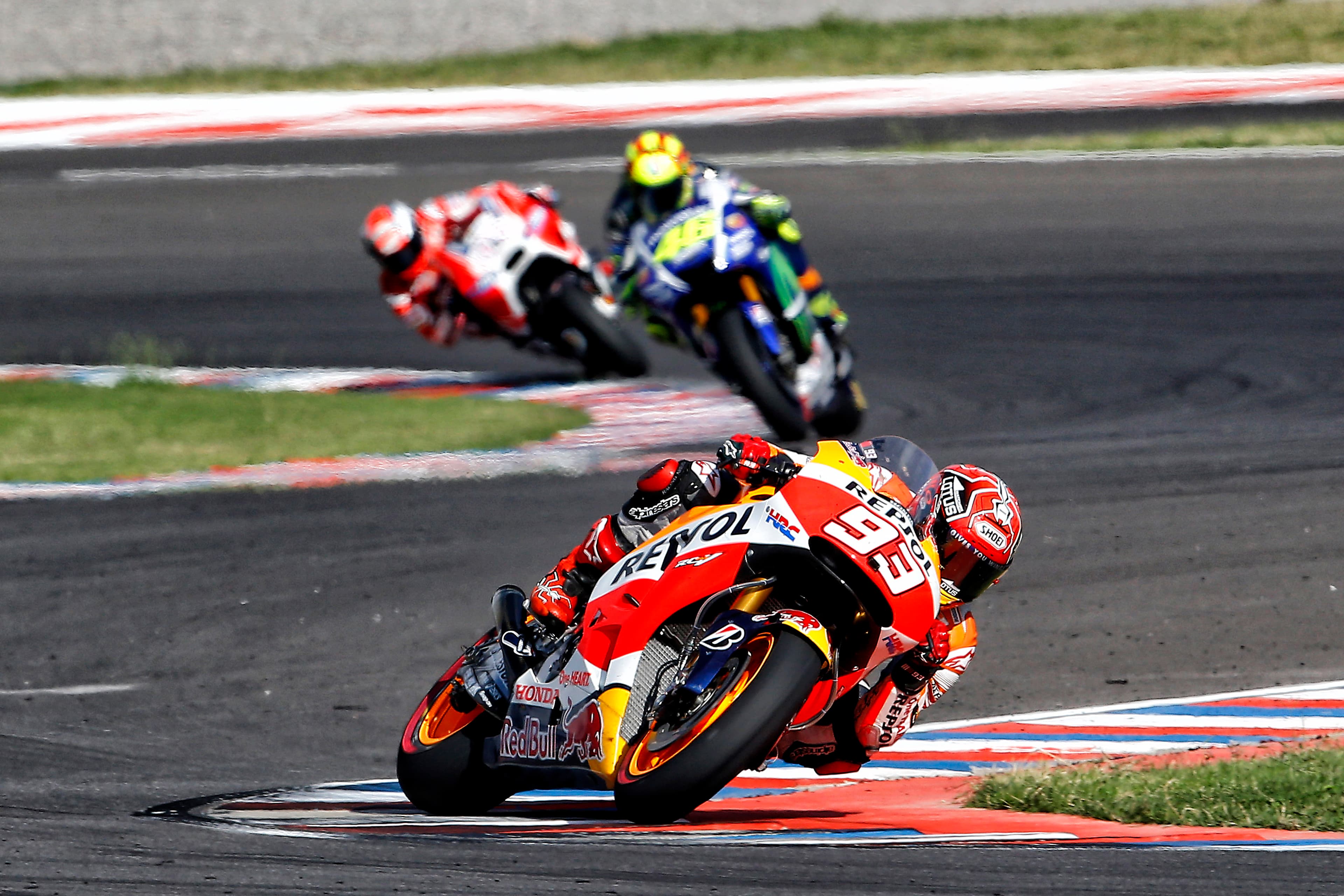 Marc Márquez, riding his Repsol Honda, being followed by the Movistar Yamaha of Valentino Rossi and the Factory Ducati of Andrea Dovizioso at the 2015 Argentine Grand Prix.