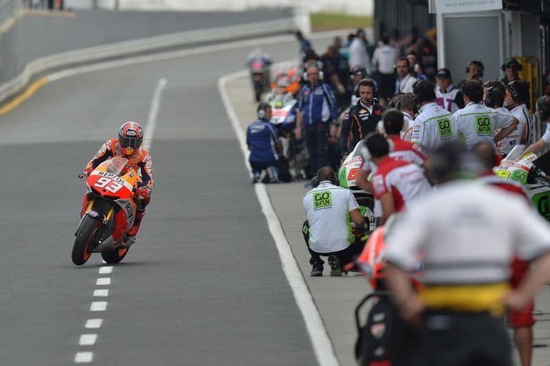 Marc Márquez, riding his Repsol Honda, riding out of his side in the pit lane after swapping his bike at the 2013 Australian Grand Prix.