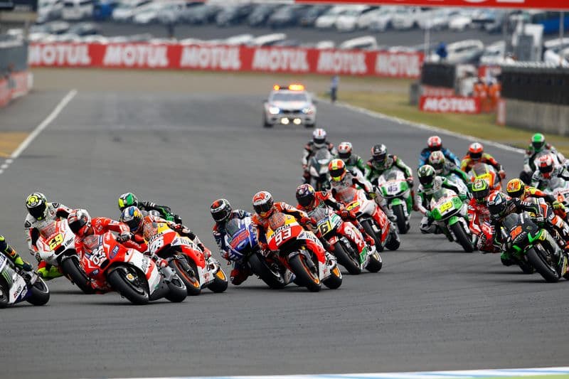 Valentino Rossi, riding his Movistar Yamaha, leading the pack on the opening lap at the 2014 Japanese Grand Prix.